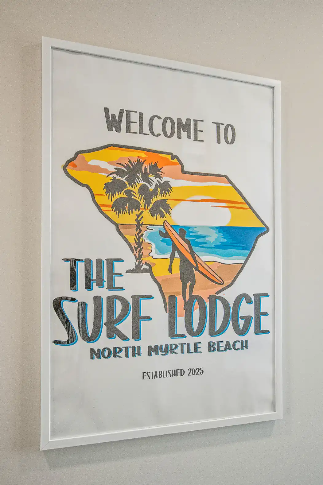Colorful welcome sign featuring a surf theme and palm trees