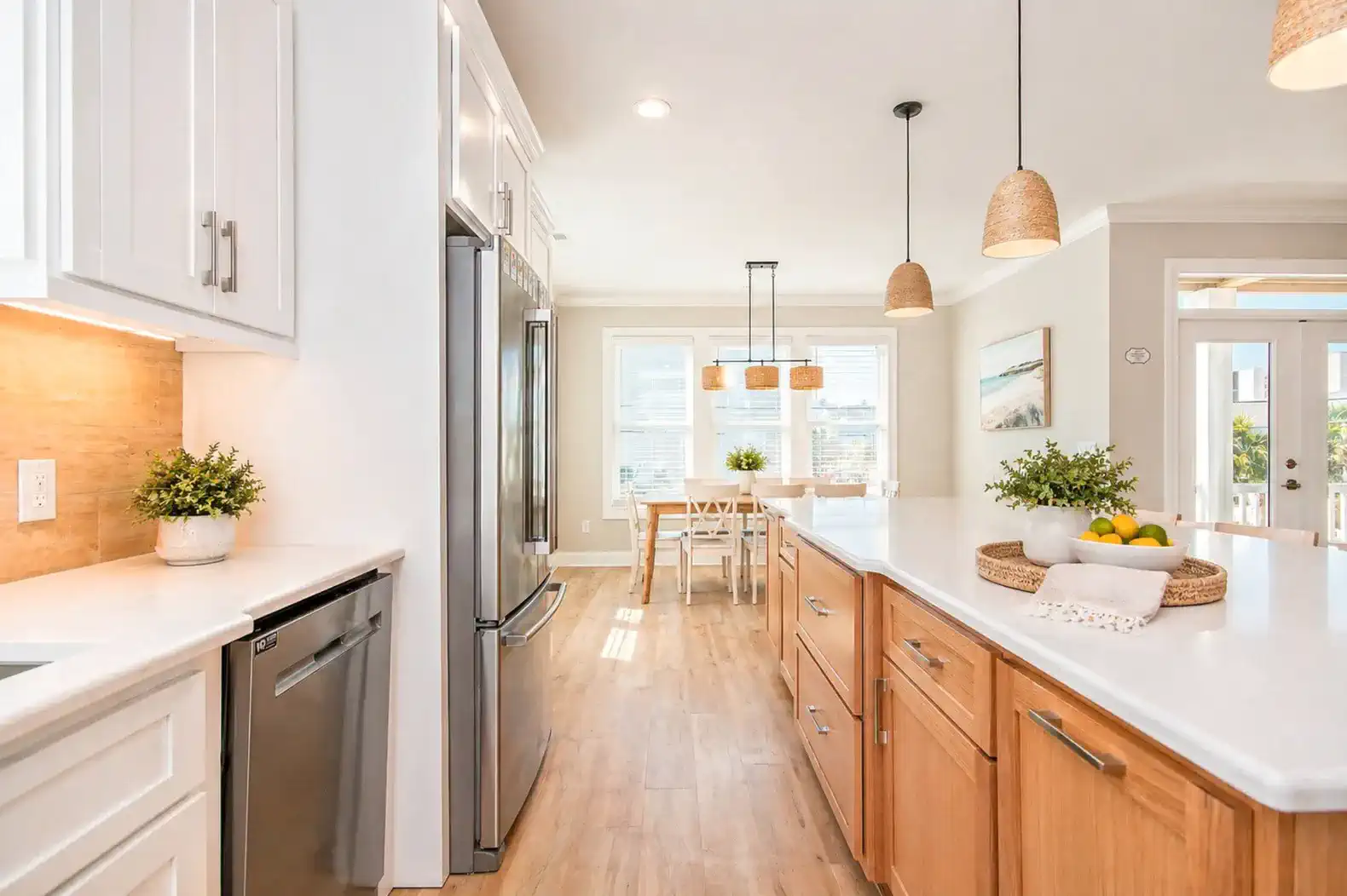 Bright and modern kitchen with stainless steel appliances and dining area