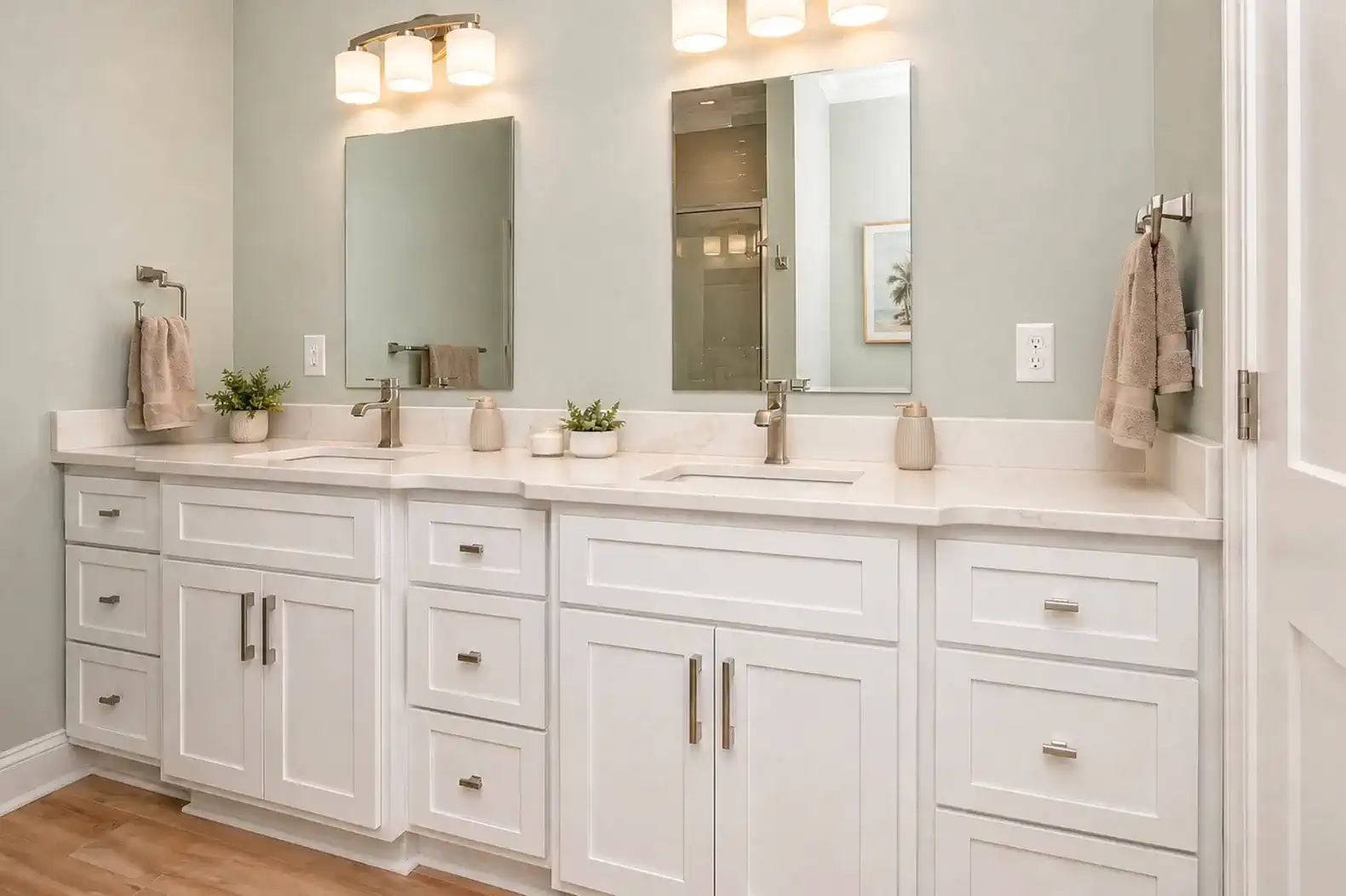 Spacious bathroom with dual sinks, modern fixtures, and light green walls