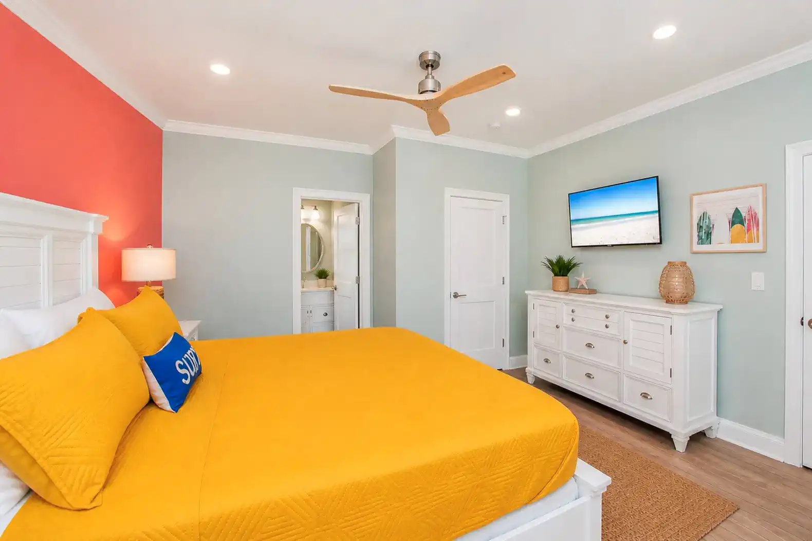 Brightly colored master bedroom with yellow bedding and modern decor