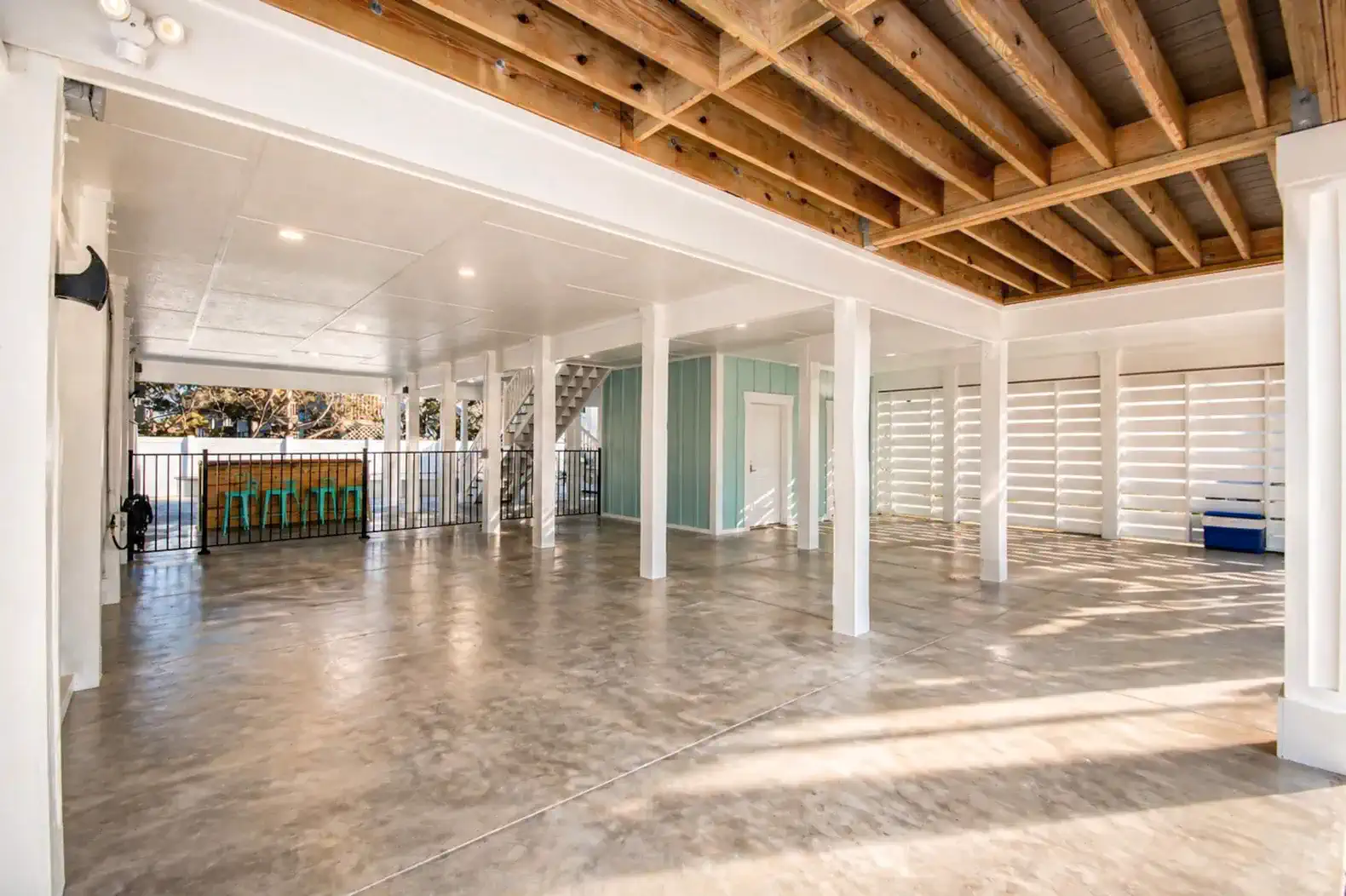 Spacious outdoor area with concrete flooring and exposed beams