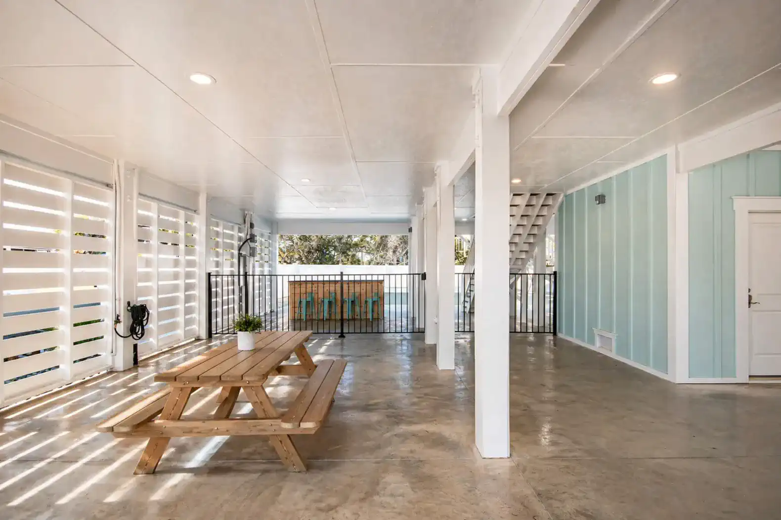 Covered outdoor area with picnic table and concrete flooring