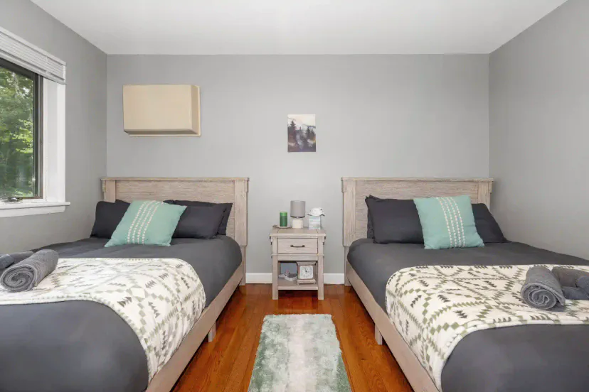 Cozy guest bedroom with two twin beds and natural light
