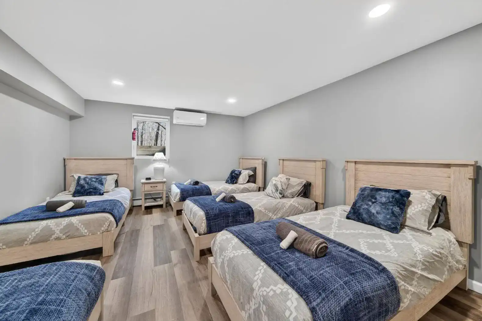 Spacious guest bedroom with multiple twin beds and modern decor