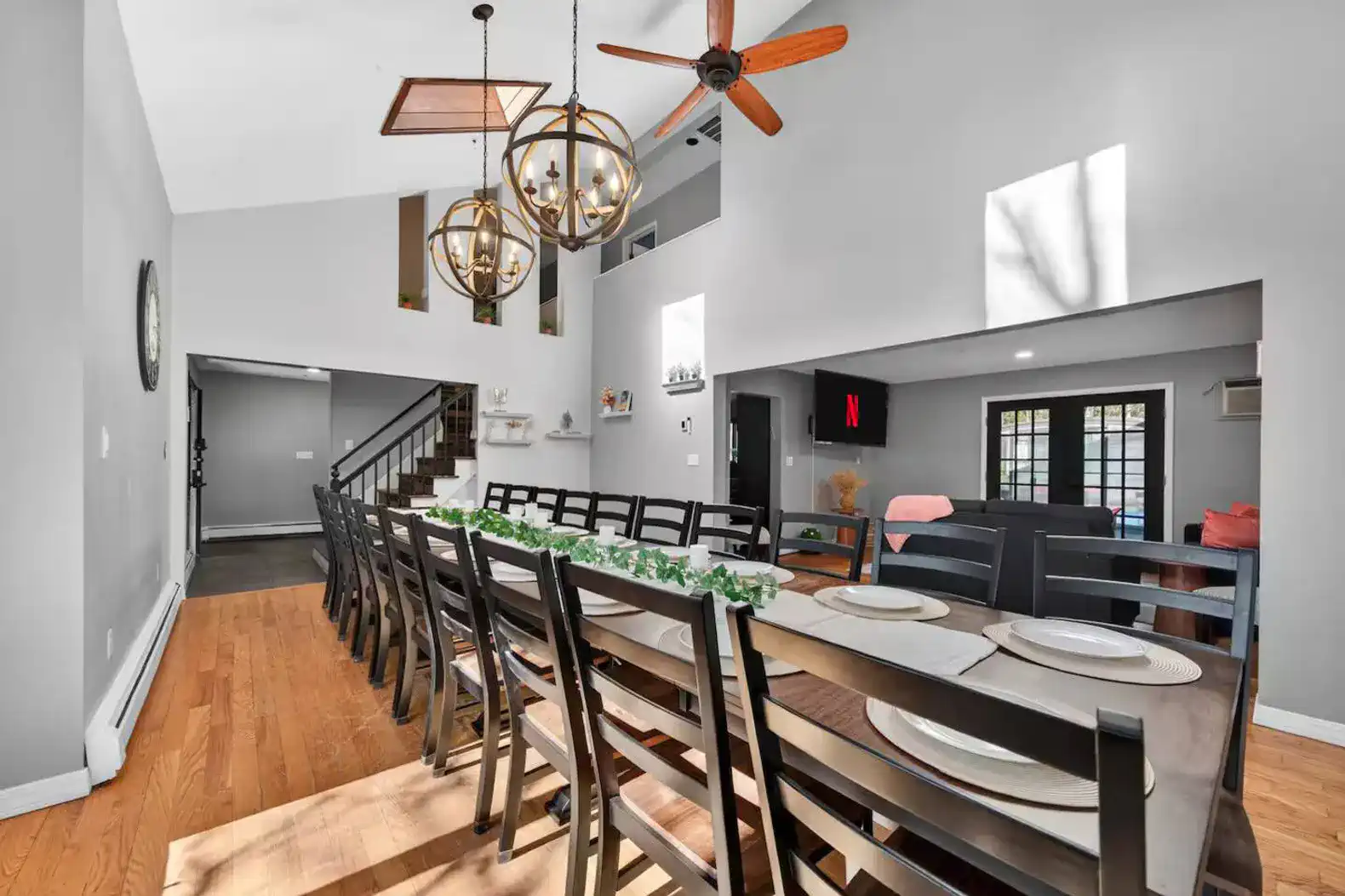 Spacious dining area with large table and modern lighting fixtures