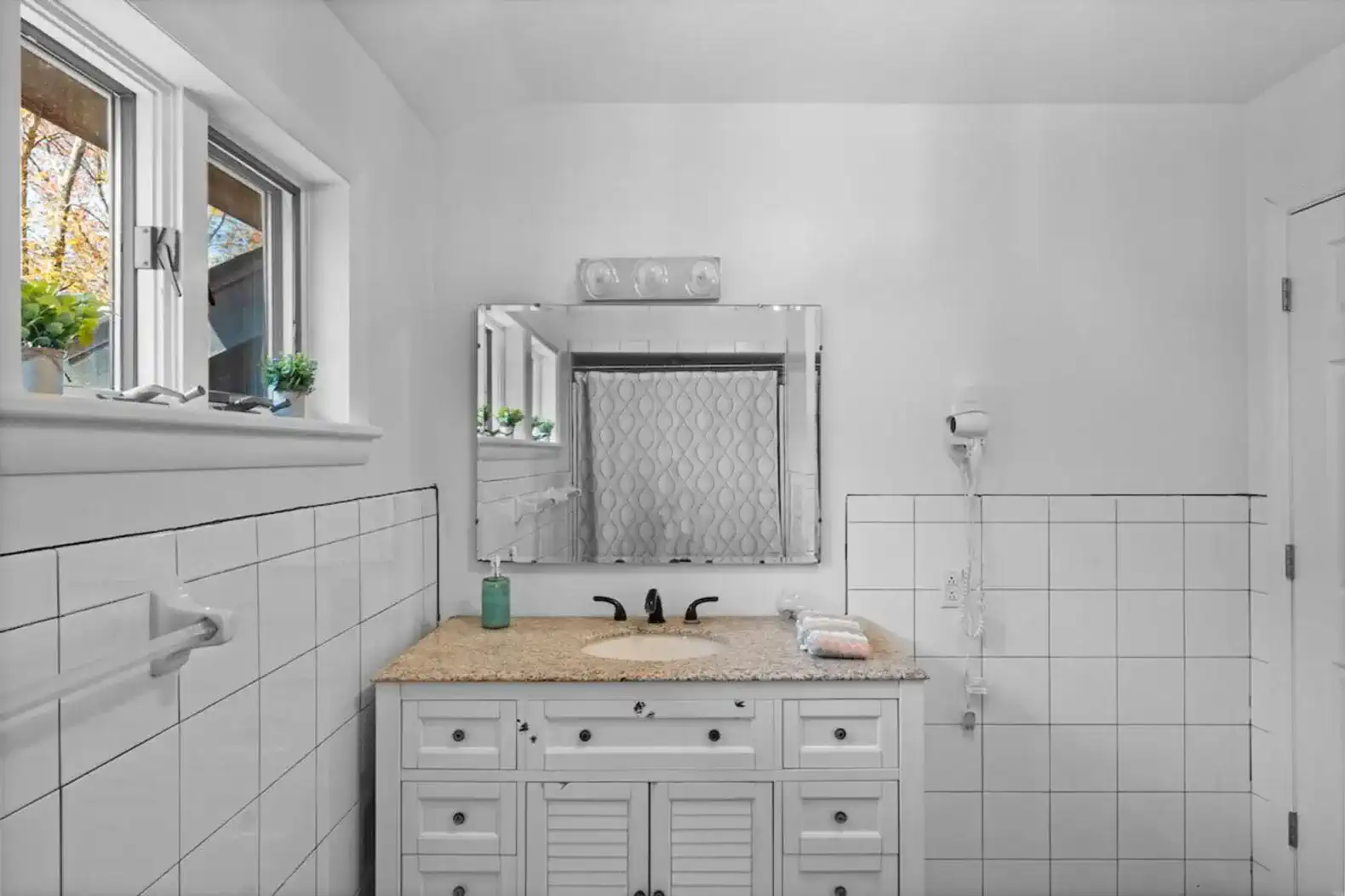 Crisp white finishes, spacious vanity, and thoughtful details for a relaxing experience.