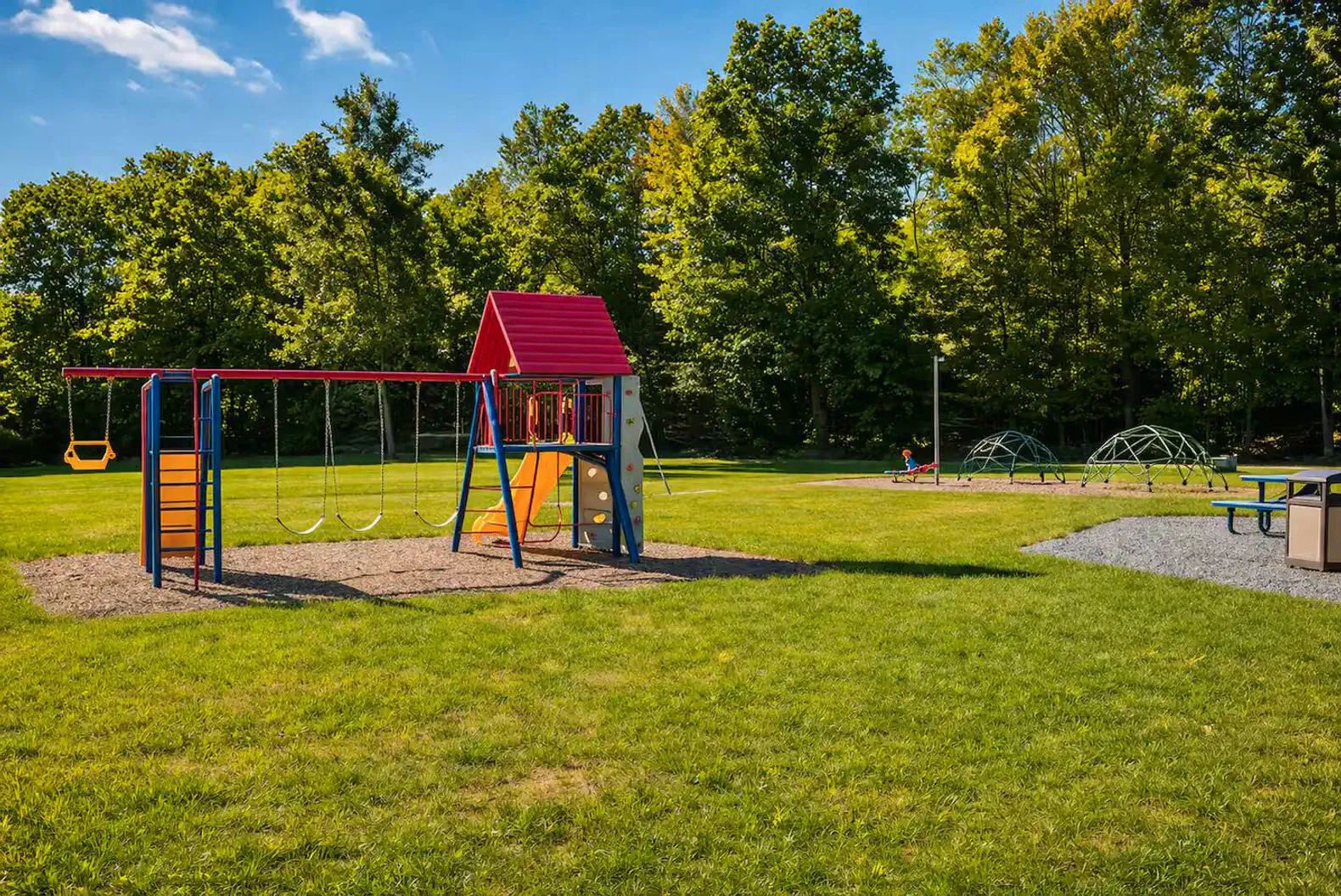 Community playground and open field ideal for family fun and outdoor activities