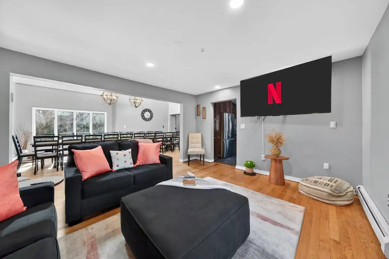 Open living room with smart TV, huge dining table, and cozy seating
