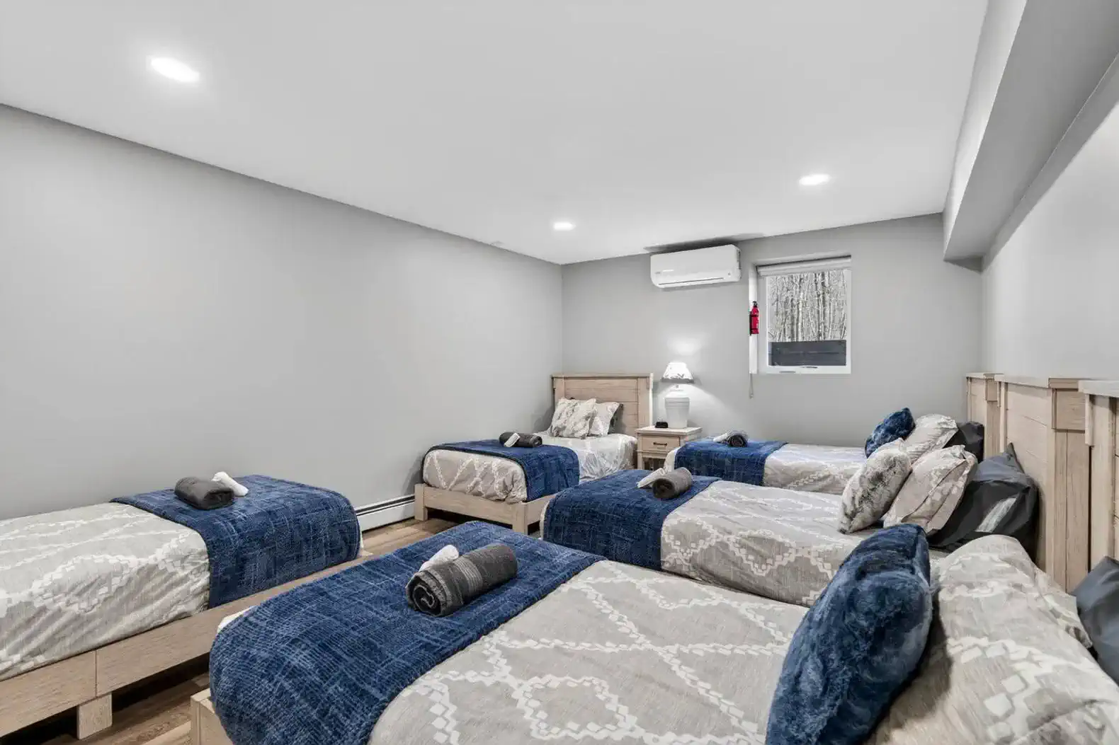 Spacious bunk room with multiple beds and cozy decor