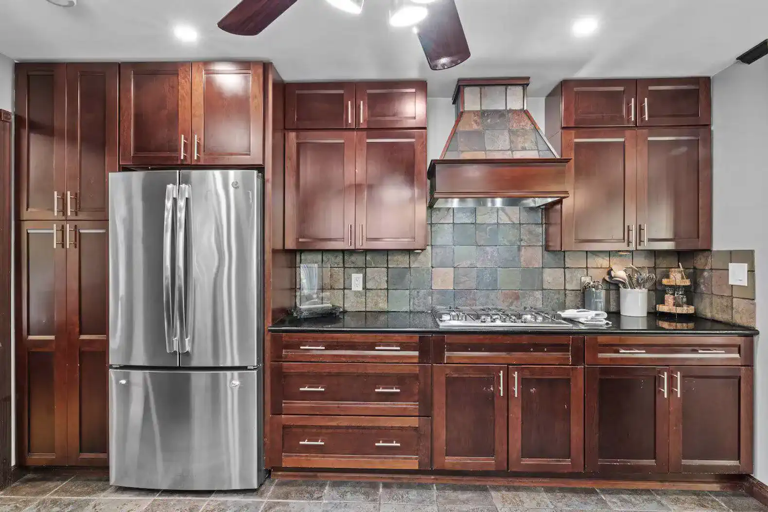 Spacious layout with stainless steel appliances and large windows showcasing scenic forest views