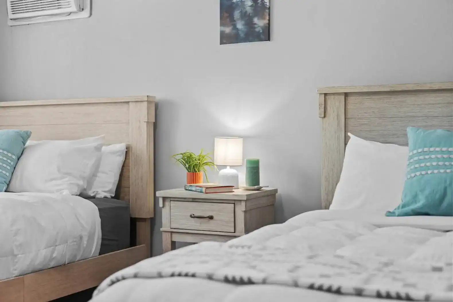 Cozy guest bedroom with two beds and bedside table