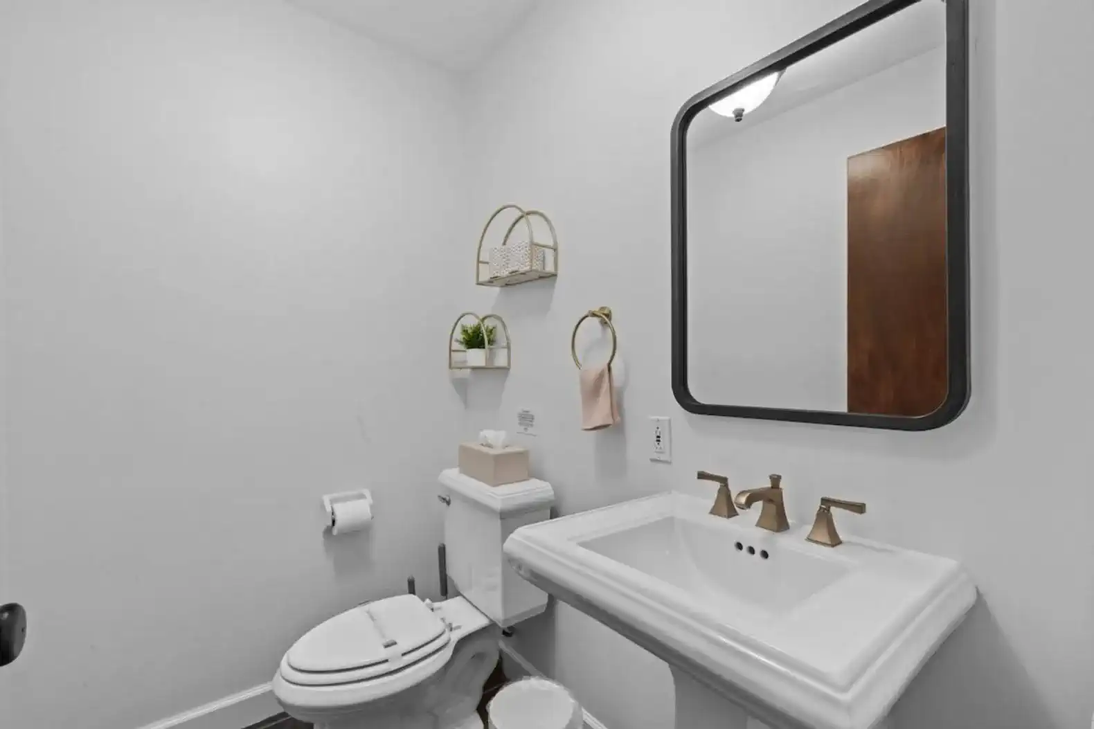 Stylish half bath featuring modern fixtures, soft lighting, and thoughtful touches Conveniently located for guests to freshen up with ease during their stay.