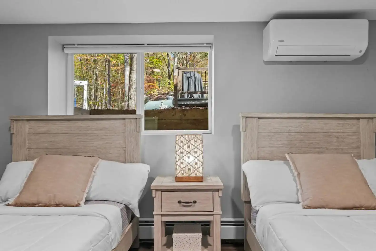 Large windows bring in natural light with peaceful views of the surrounding woods.