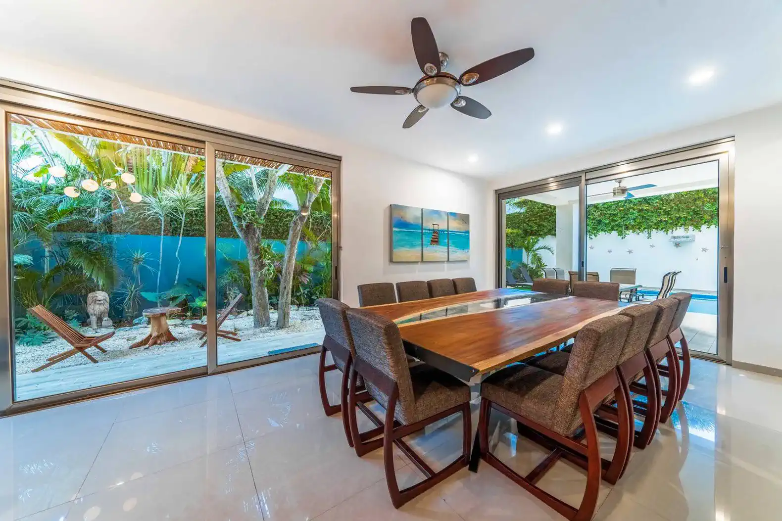 Spacious dining area with large wooden table and views of the outdoor garden
