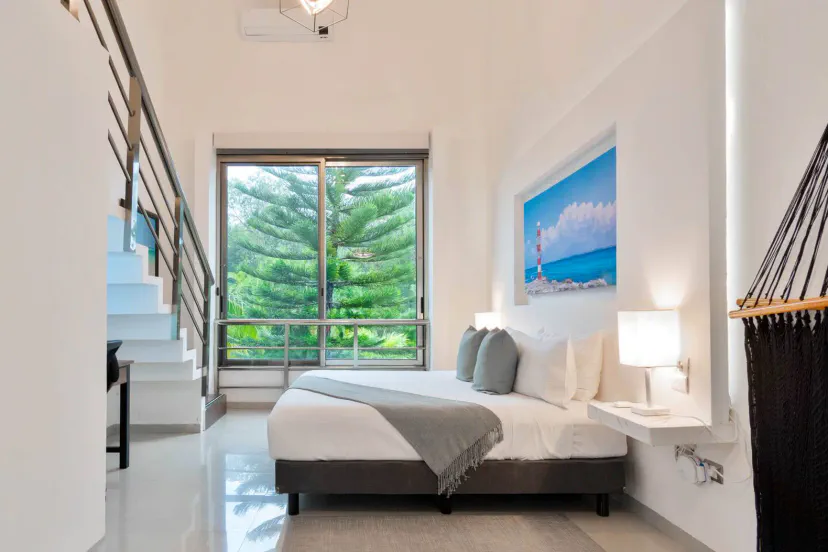 Bright room with a large bed and garden view