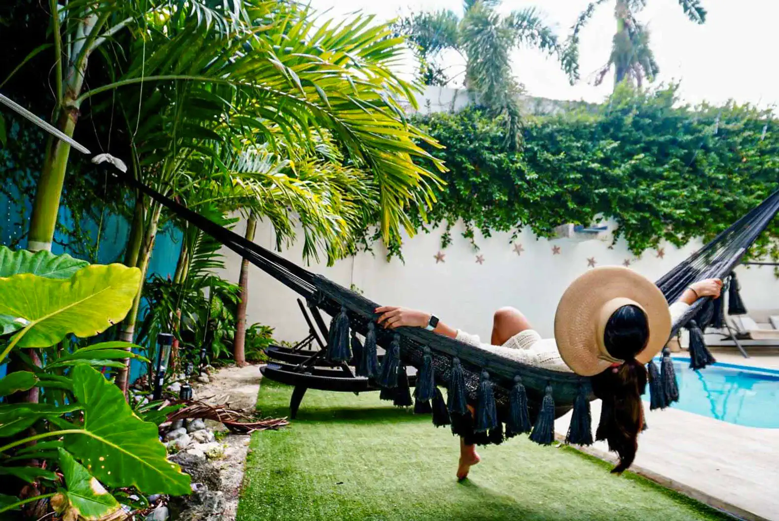 Relaxing in a hammock surrounded by lush greenery and a private heated pool