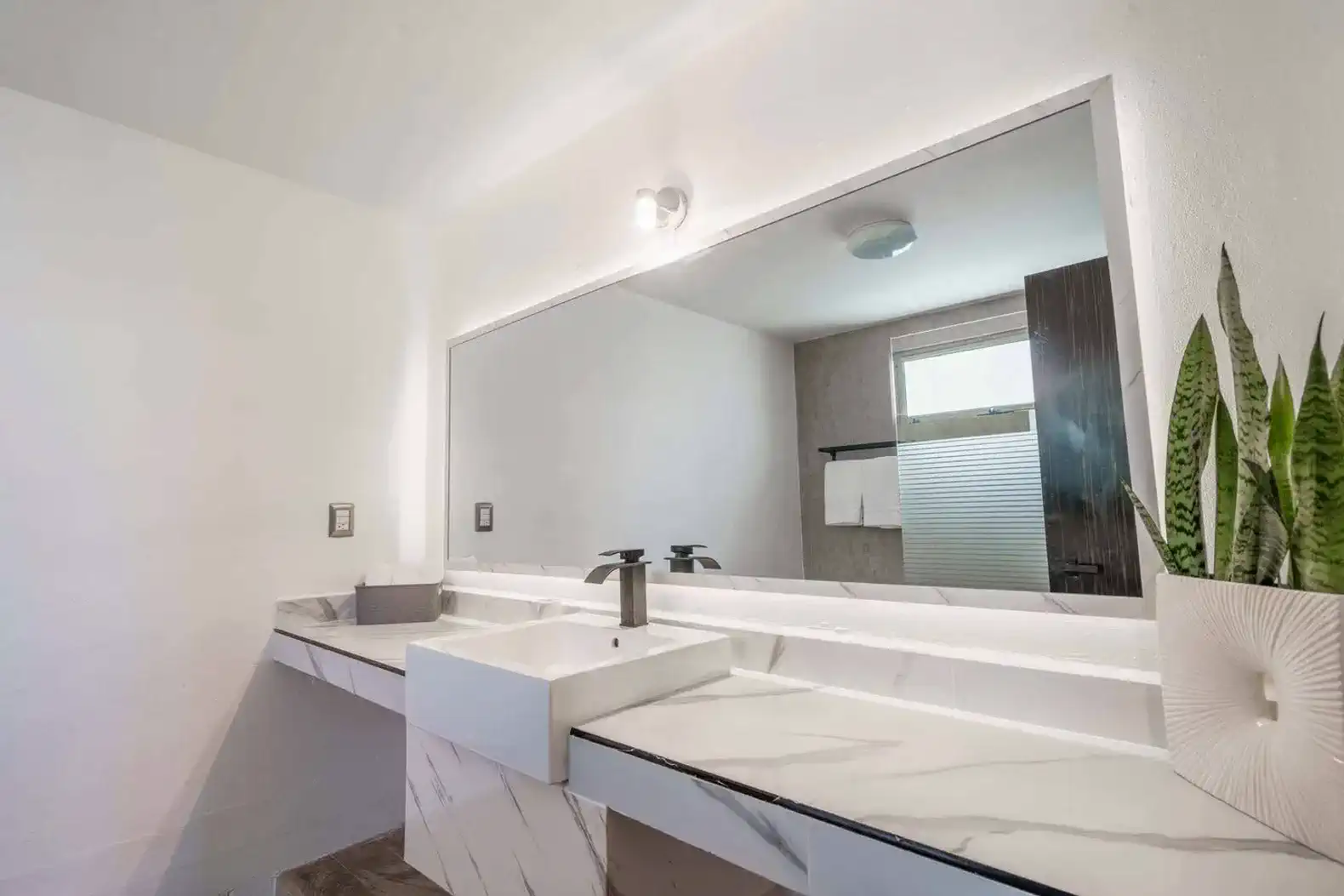 Baño moderno con lavabo elegante y espejo grande