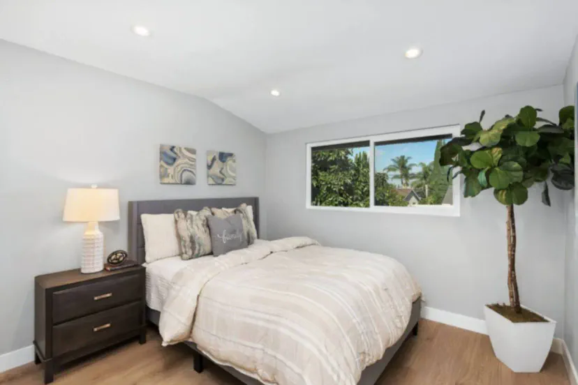 Cozy guest bedroom with a comfortable bed and natural light from the window