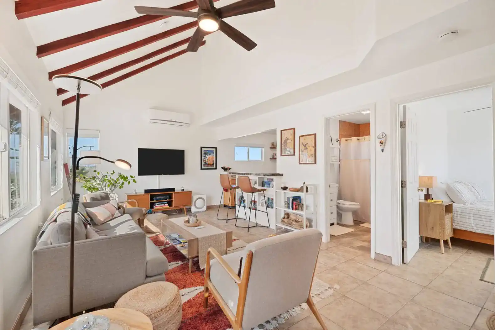 Bright living room with vaulted ceiling, modern decor, and cozy seating area