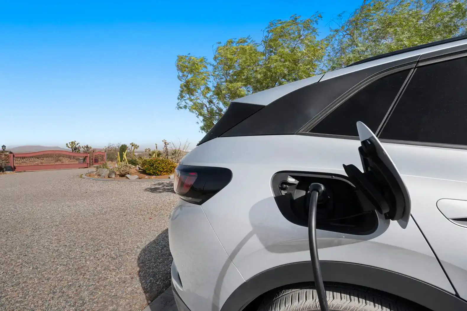 Electric vehicle charging station with scenic desert backdrop