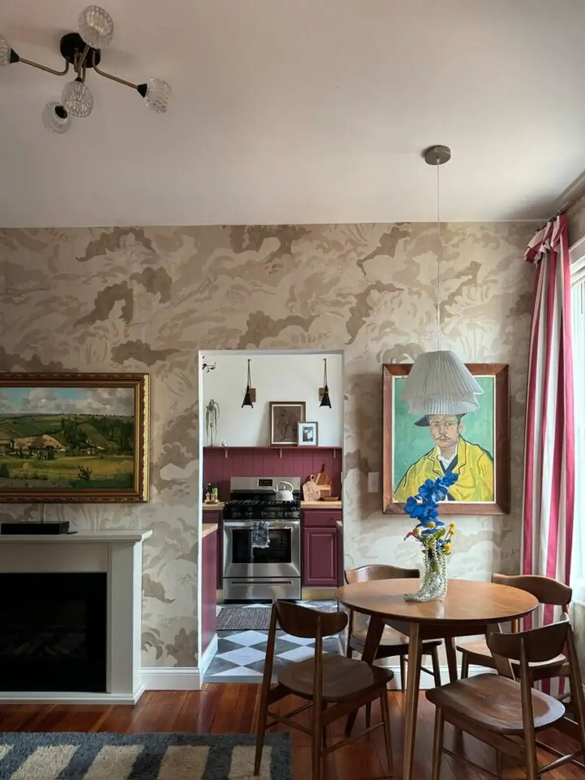 Cozy dining area with a round table, vintage decor, and a view into the kitchen