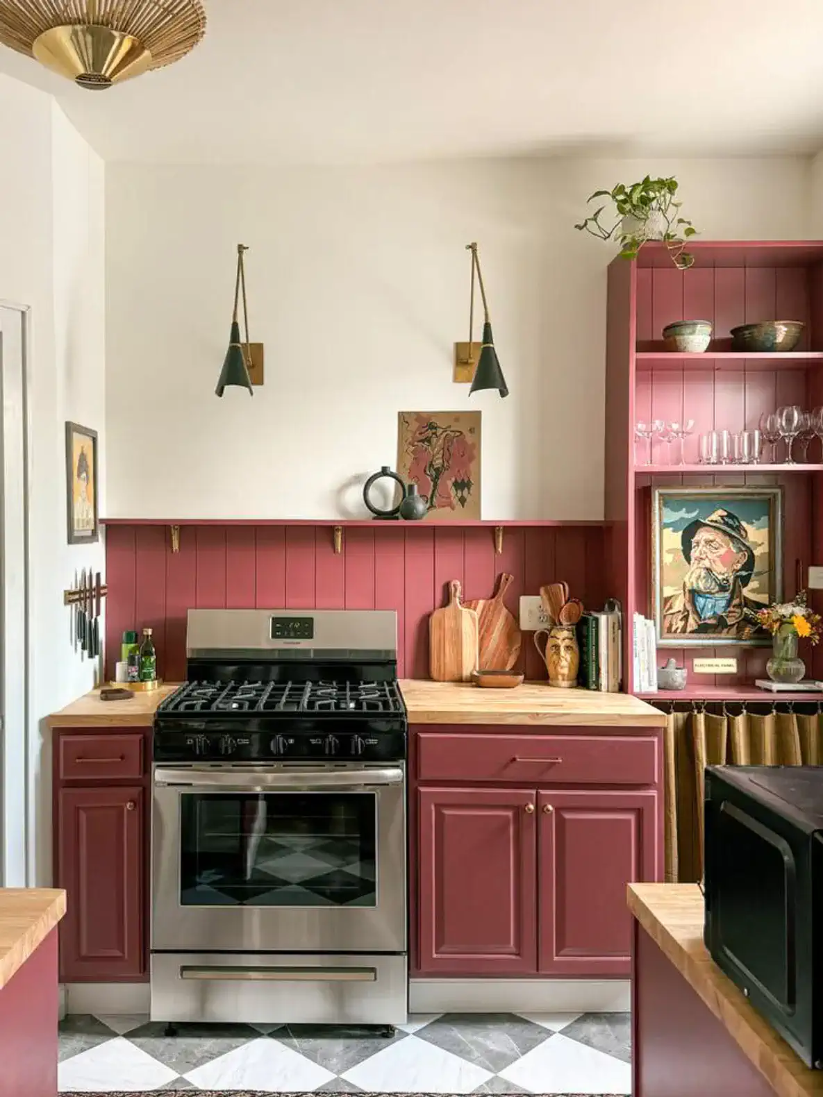 Charming kitchen with maroon cabinets, stainless steel appliances, and wooden countertops