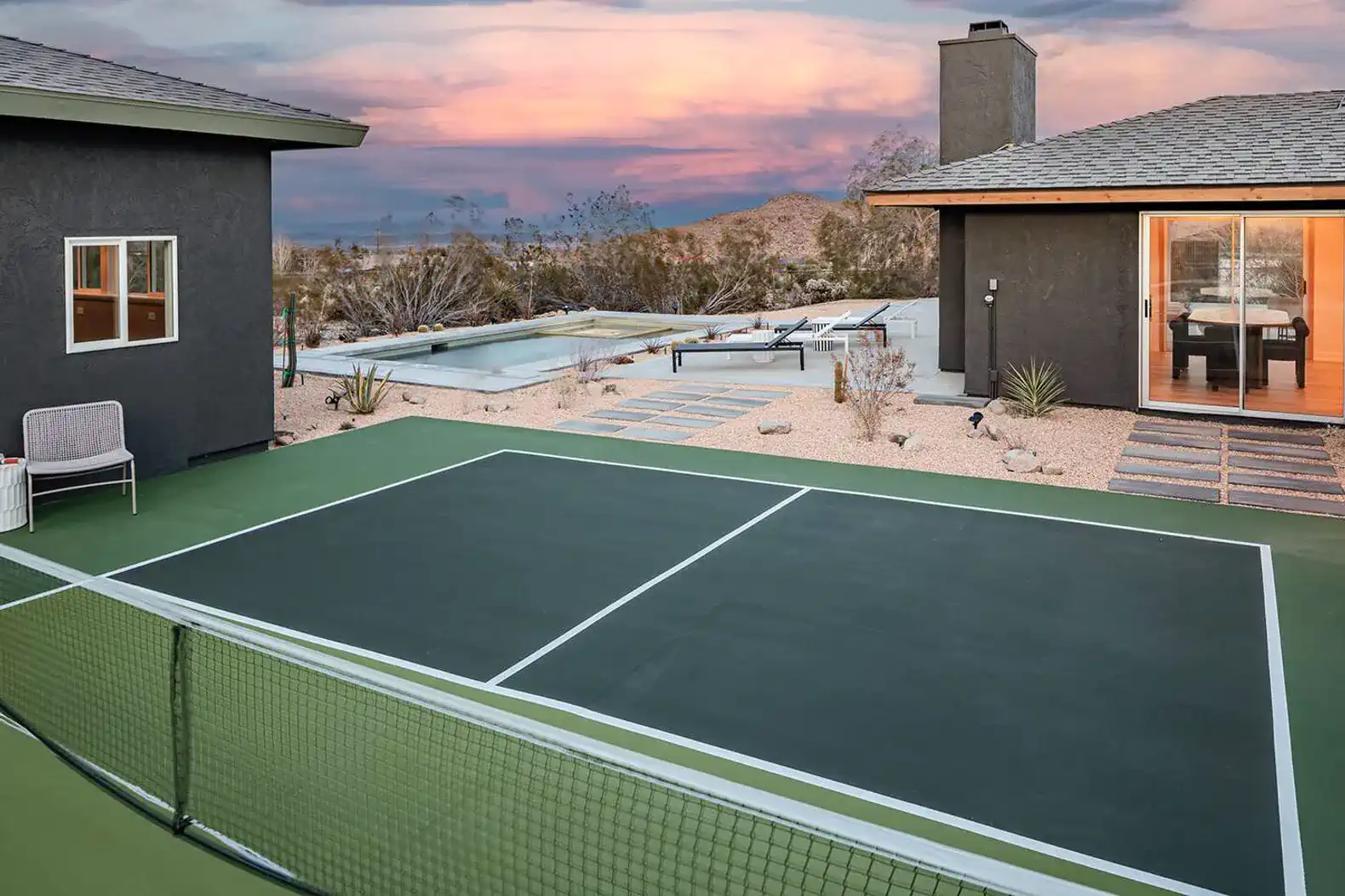Pickleball court with desert landscape and sunset in the background