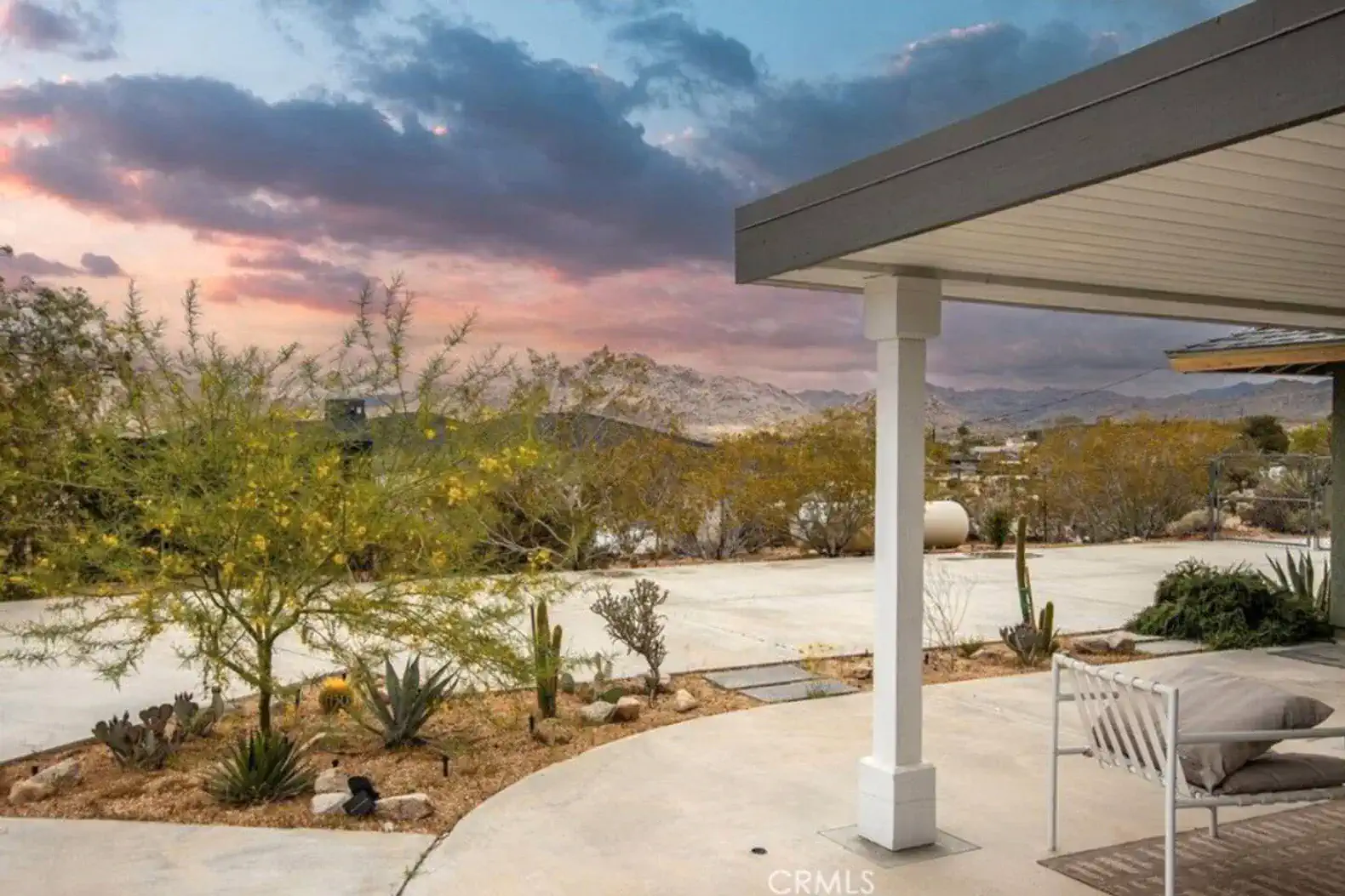 Desert landscape with mountains and colorful sunset in the background