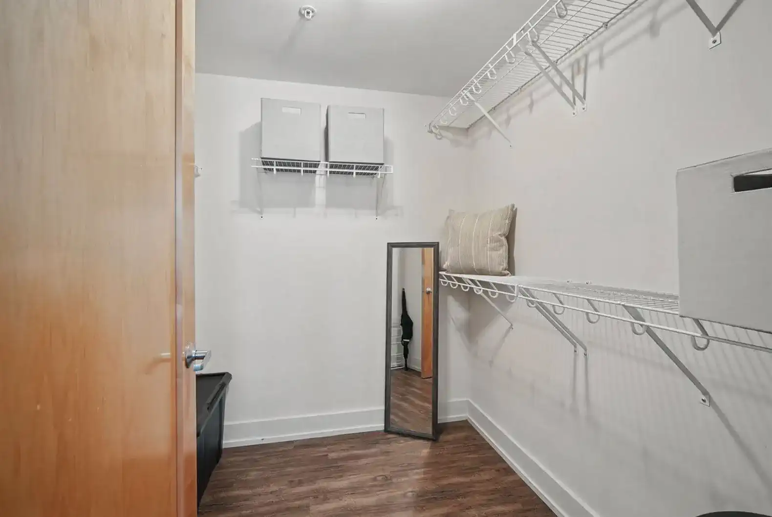 Plenty of storage space in the walk-in closet—includes shelving, storage bins, a full-length mirror, and hangers to keep your wardrobe organized.