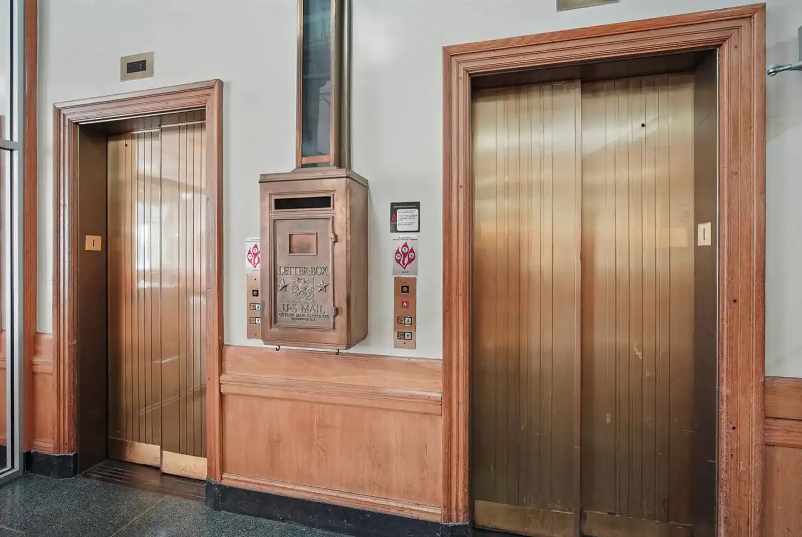 A rare find—fully functional vintage elevators with an original U.S. mail chute still in place.