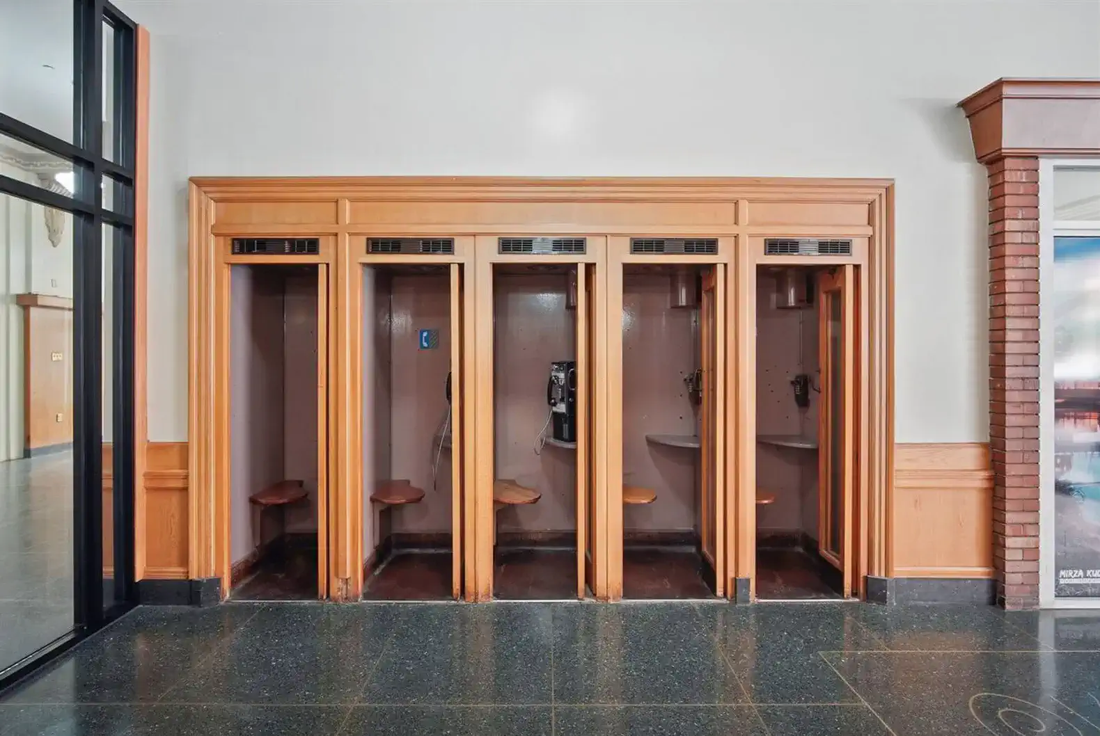 Throwback alert—these preserved wooden phone booths bring nostalgic flair and character to the building.