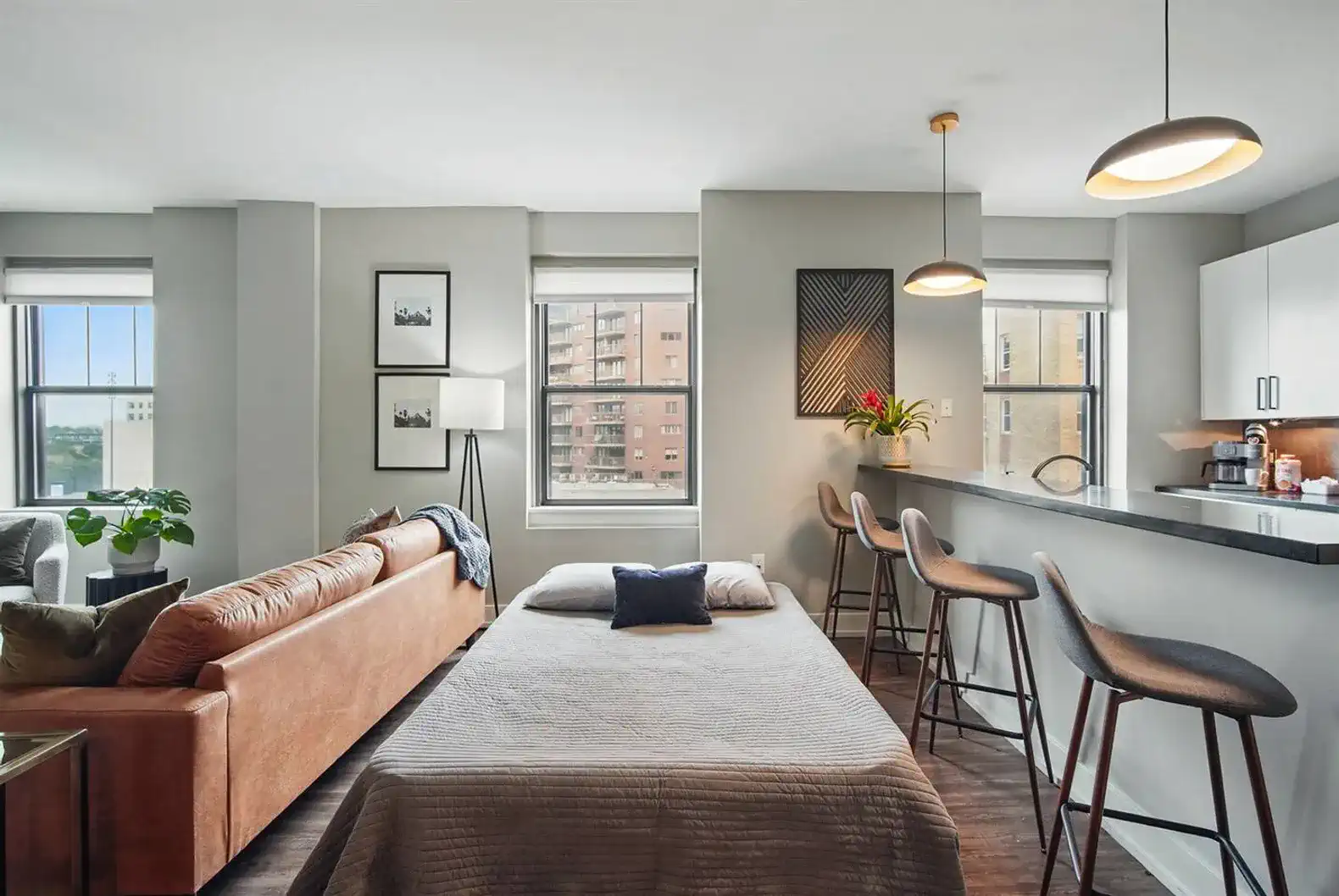 Wake up to city views in this bright, open-concept living space with a thoughtfully arranged sofa bed.