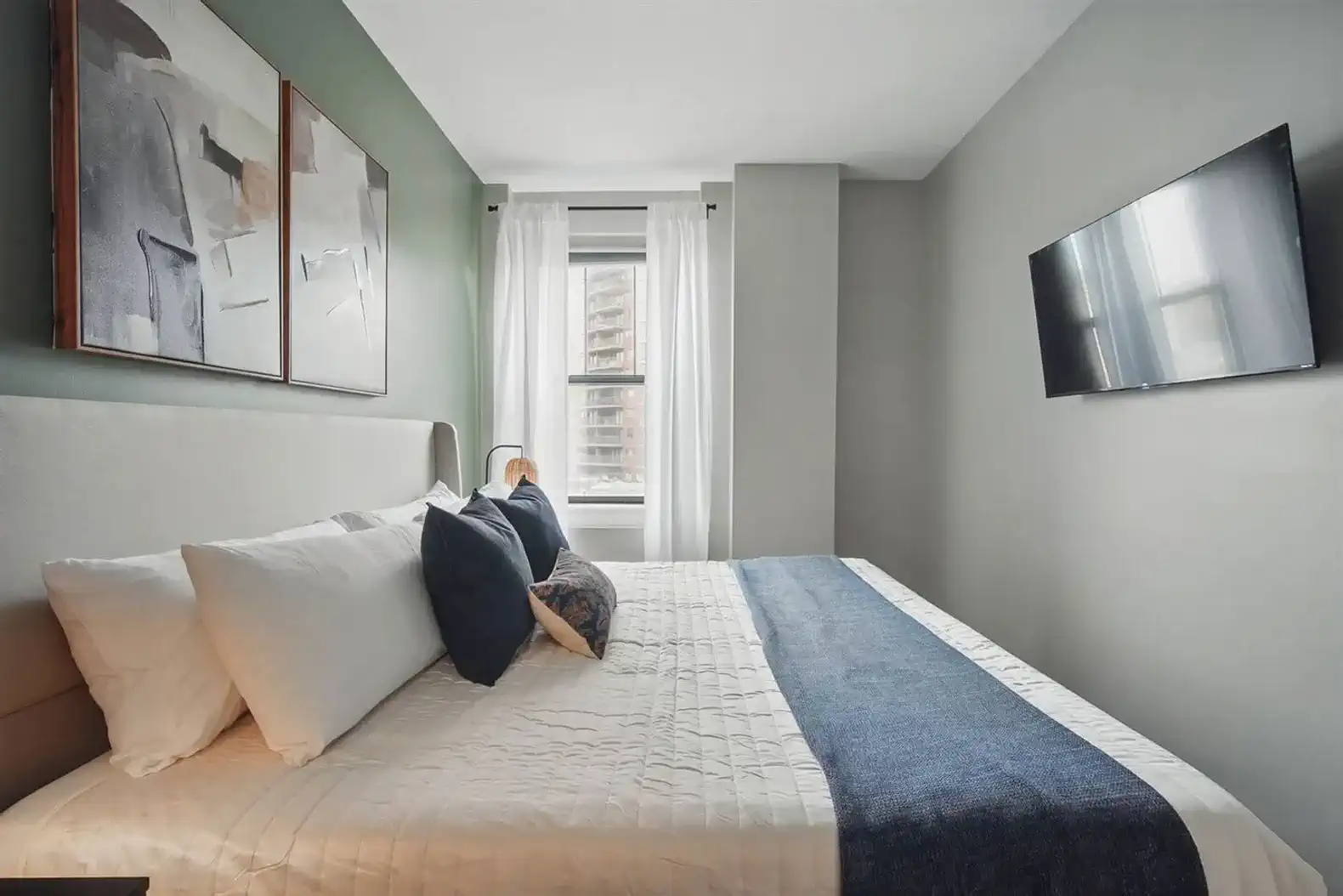 Unwind with a movie in bed or enjoy natural light from the large window. Room includes blackout curtains and a mounted smart TV for maximum comfort.