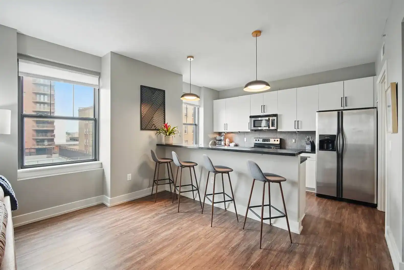Open layout with natural light, high ceilings, and city views. The perfect space for relaxing, entertaining, or working from home with a sleek, modern vibe.