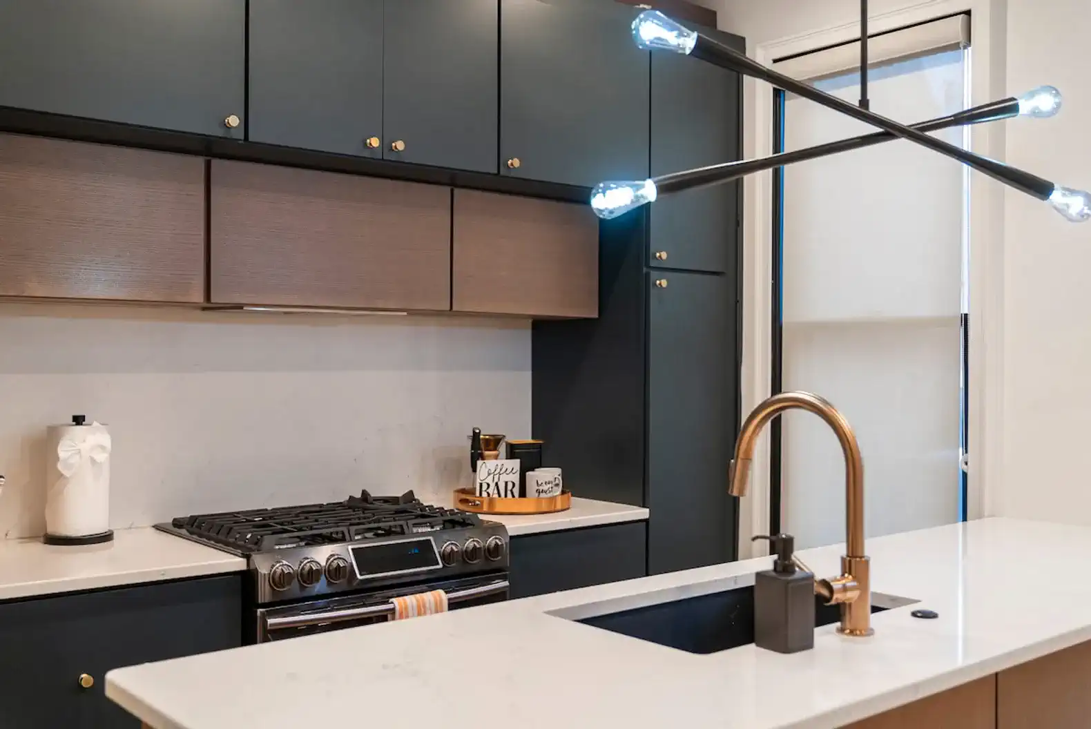 Sleek modern kitchen with dark cabinetry and stylish lighting