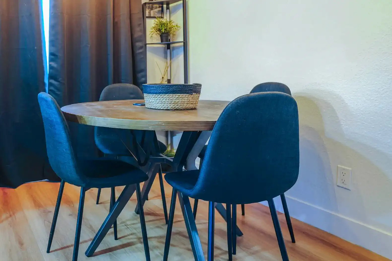 Cozy dining area with a round wooden table and four upholstered chairs