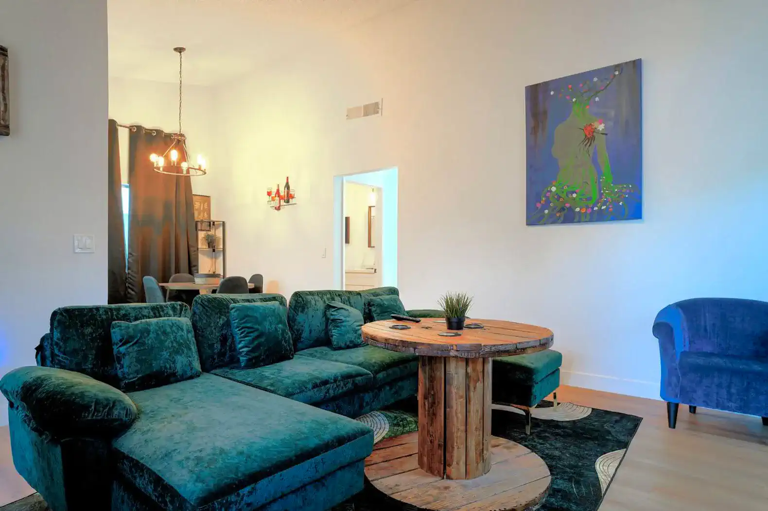 Cozy living room with green sectional sofa and unique round table