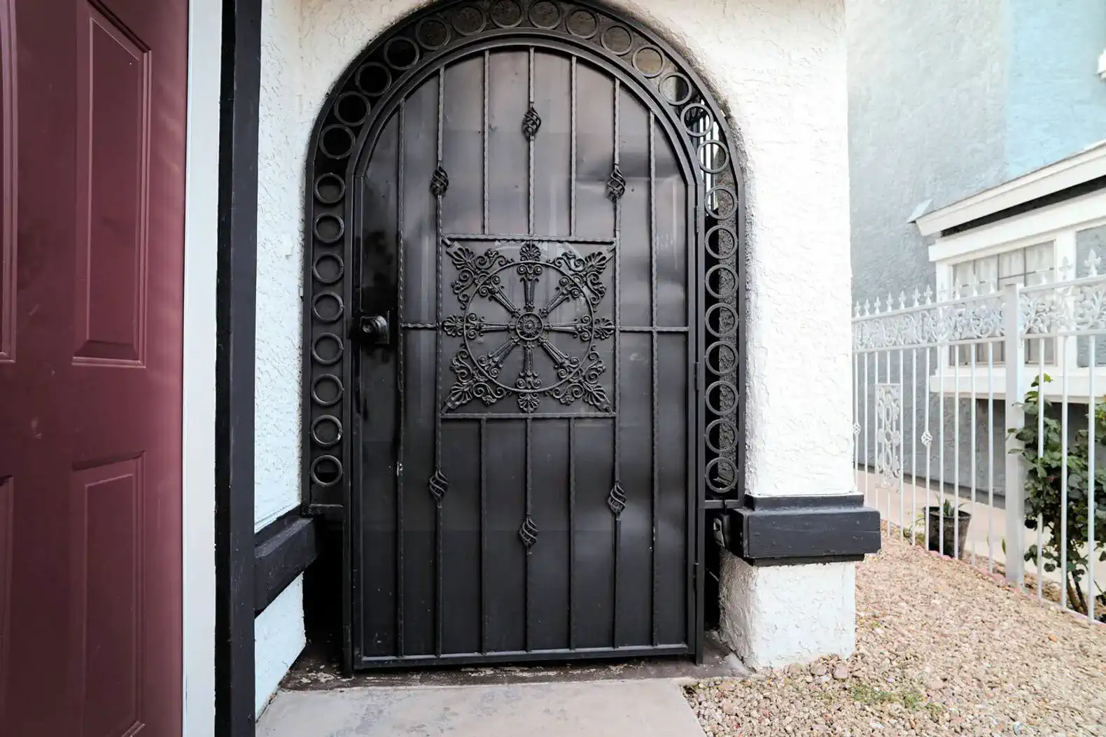 Decorative wrought iron gate leading to the entrance
