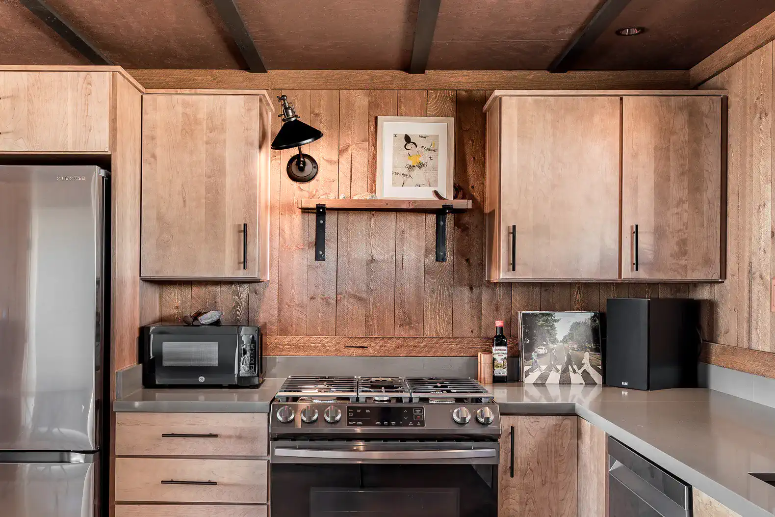 Modern kitchen with wooden cabinets, stainless steel appliances, and a sleek countertop
