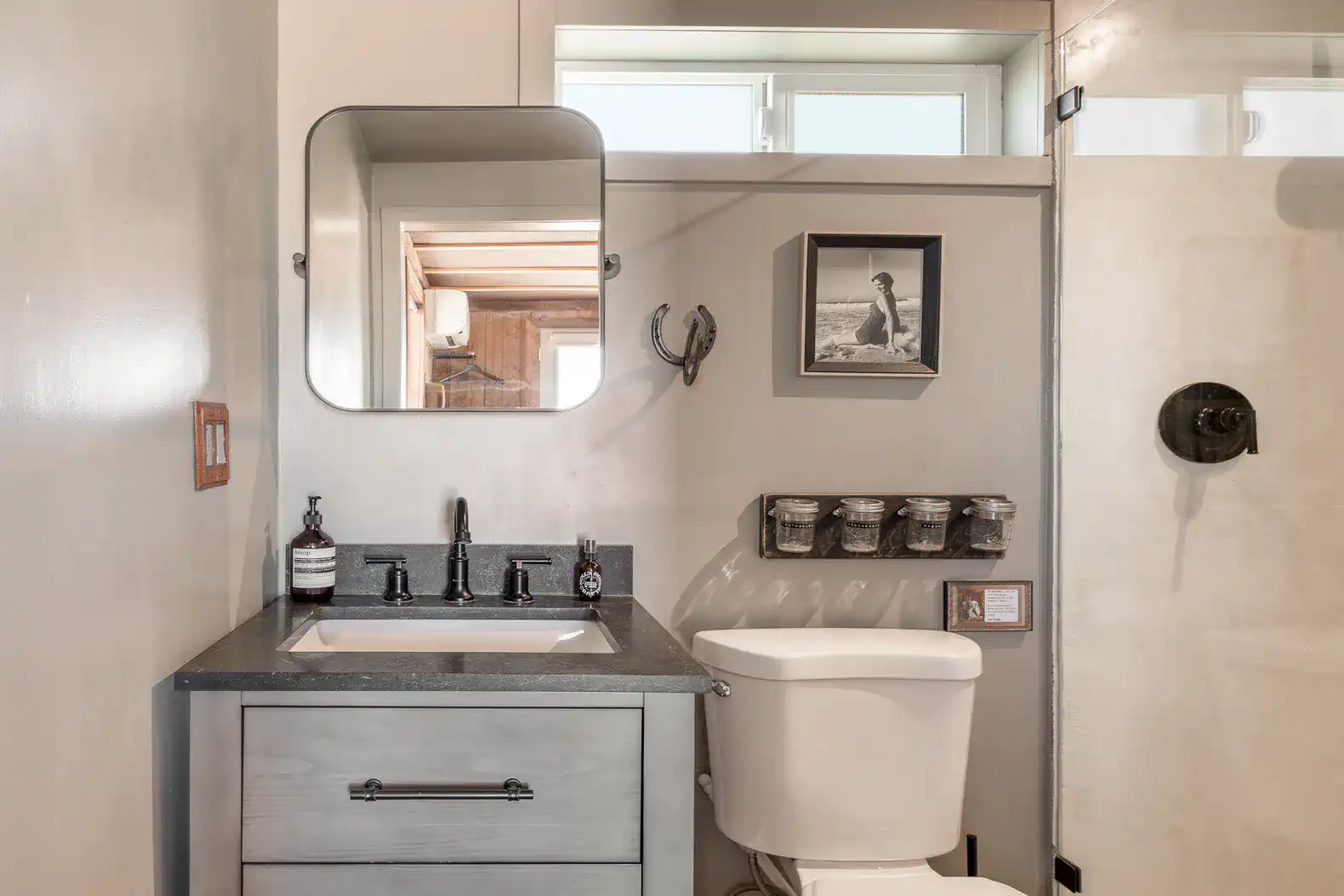 Modern bathroom with a sleek vanity, mirror, and shower area
