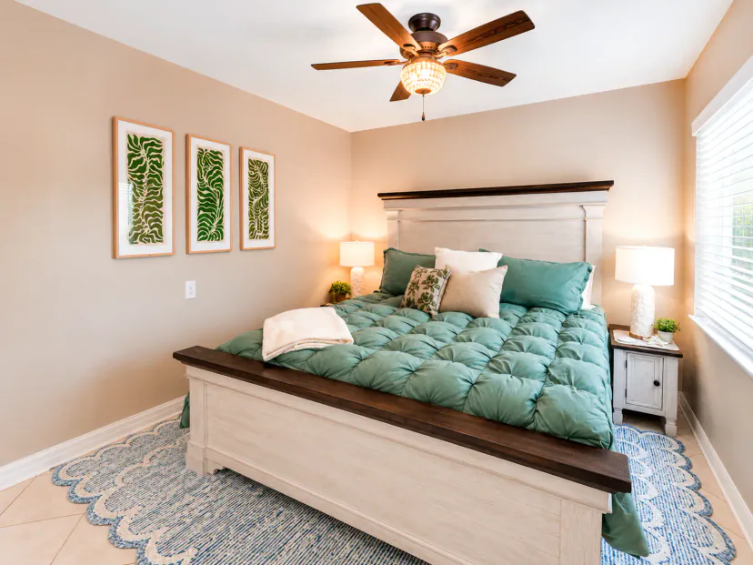 Bright, cozy bedroom with plush king bed, natural light, and stylish decor