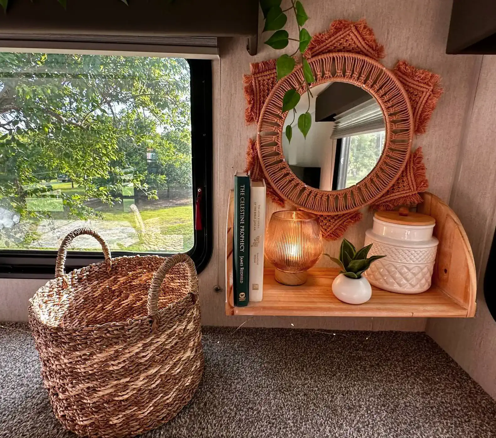 Cozy shelf with a mirror, books, and decorative items near a window