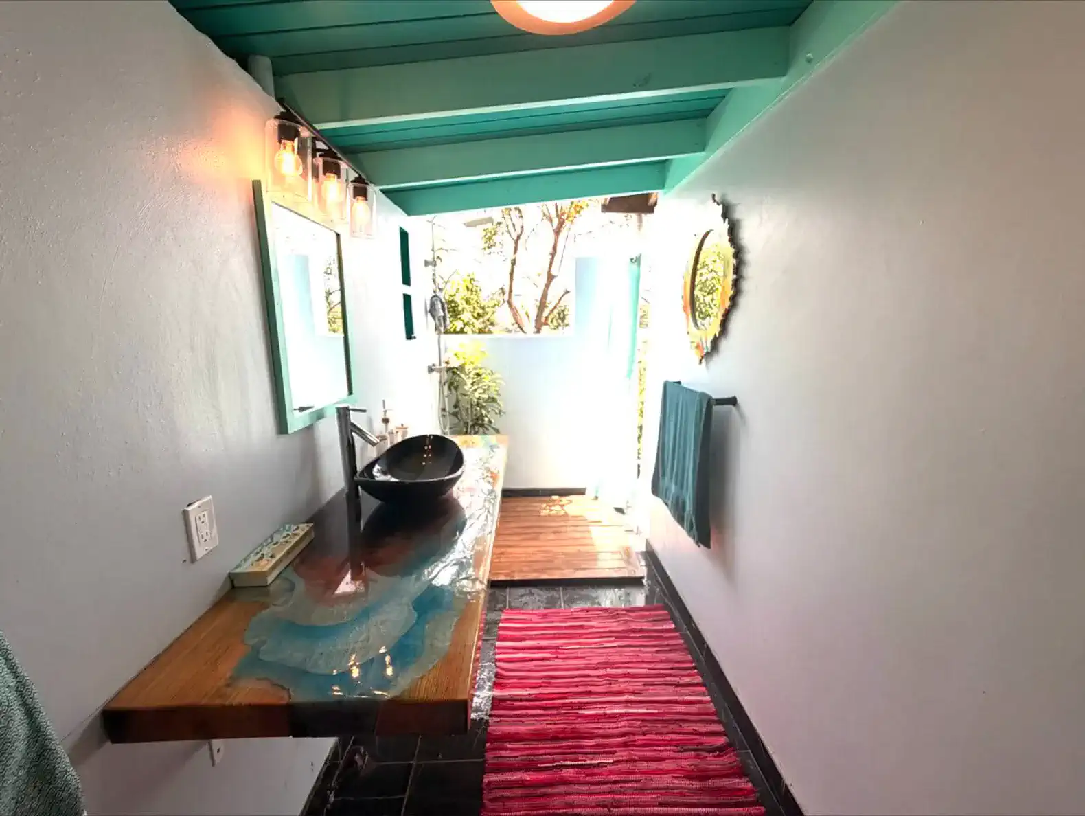 Stylish bathroom with a wooden sink counter and vibrant decor