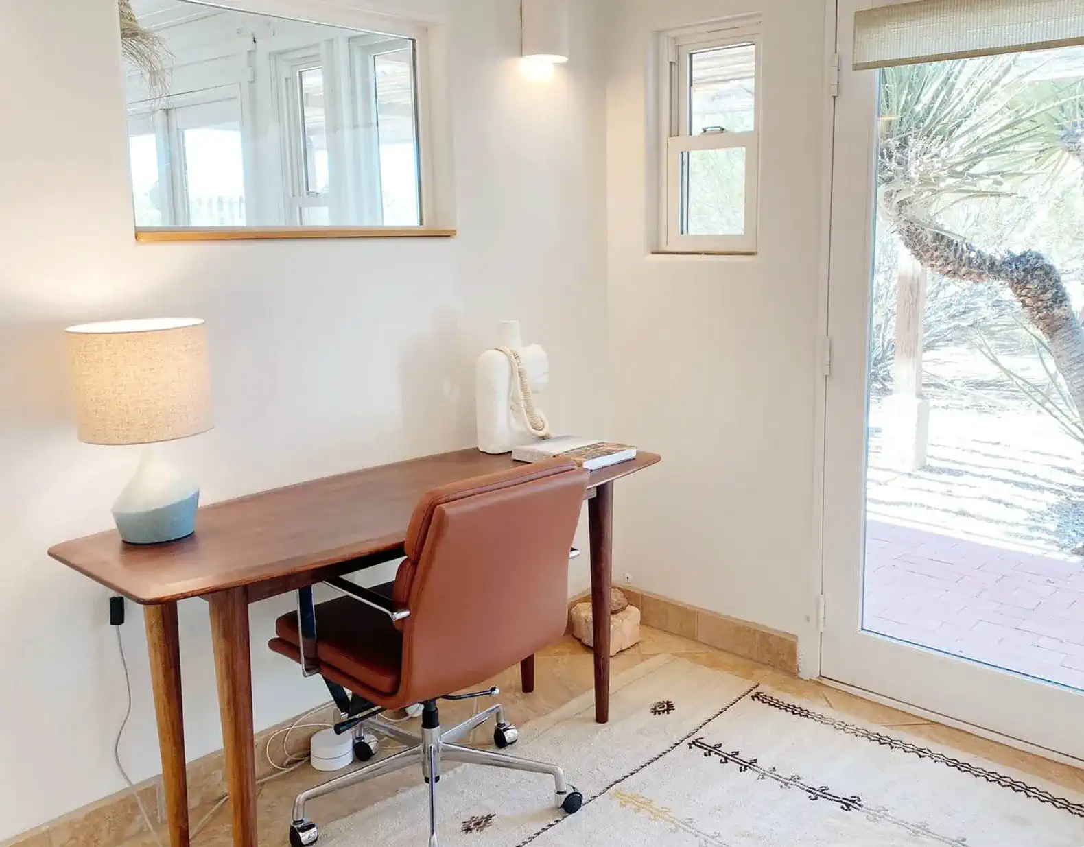 The office features a light-filled workspace with access to the front porch.