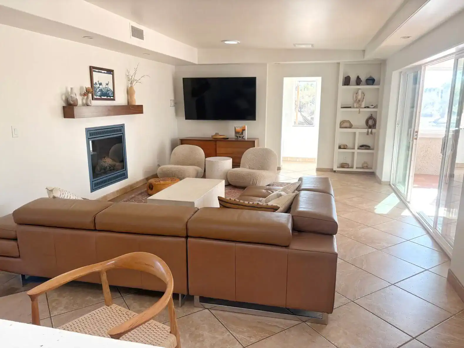 Cozy living room with a fireplace, large TV, and comfortable seating