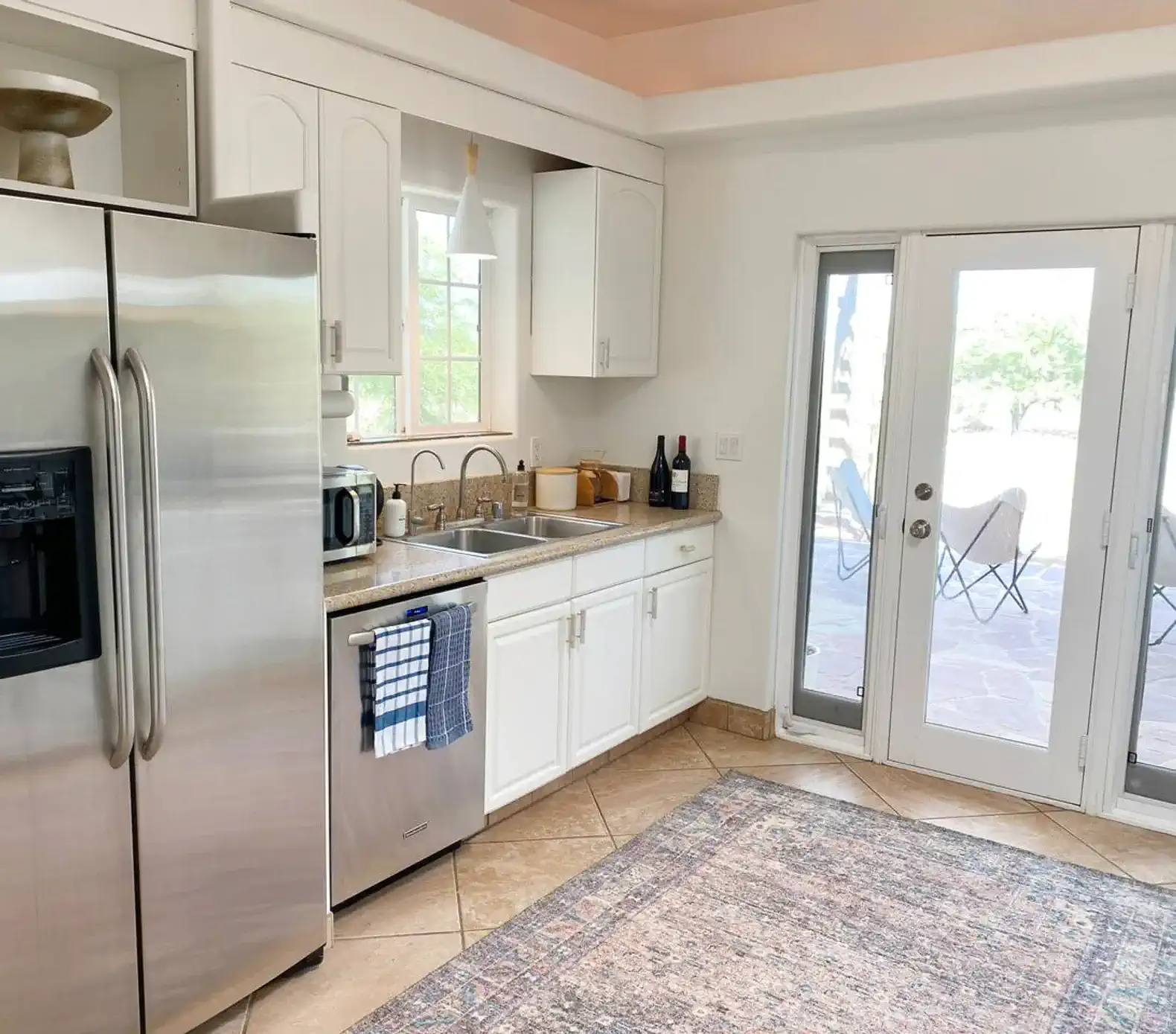 The well-appointed kitchen features a Bosch gas range and oven, dishwasher, two sinks (with separate reverse-osmosis filtered water faucet), a microwave, electric kettle, and Chemex pour-over coffee maker.