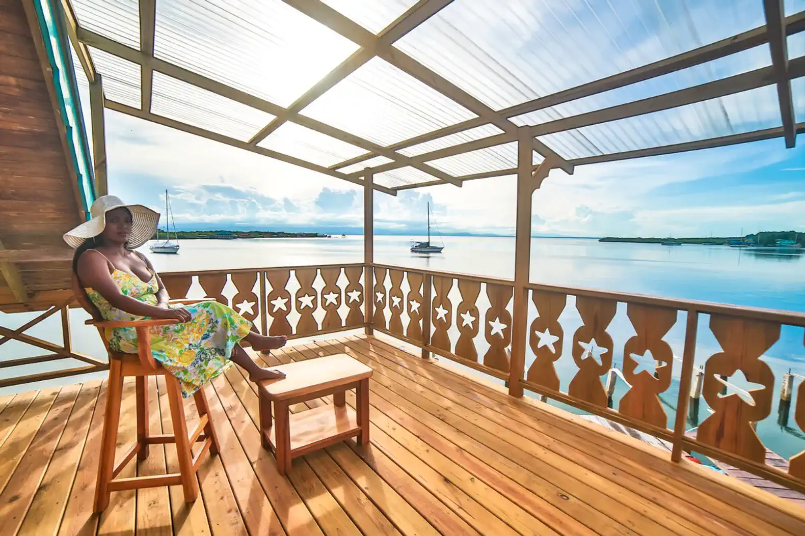 Spacious deck with a sea view and a woman relaxing in a sun hat