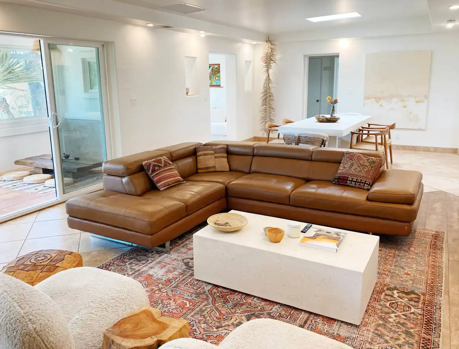 Entering the house you'll step into the light-filled and spacious living/dining room with an oversize couch and dining table.