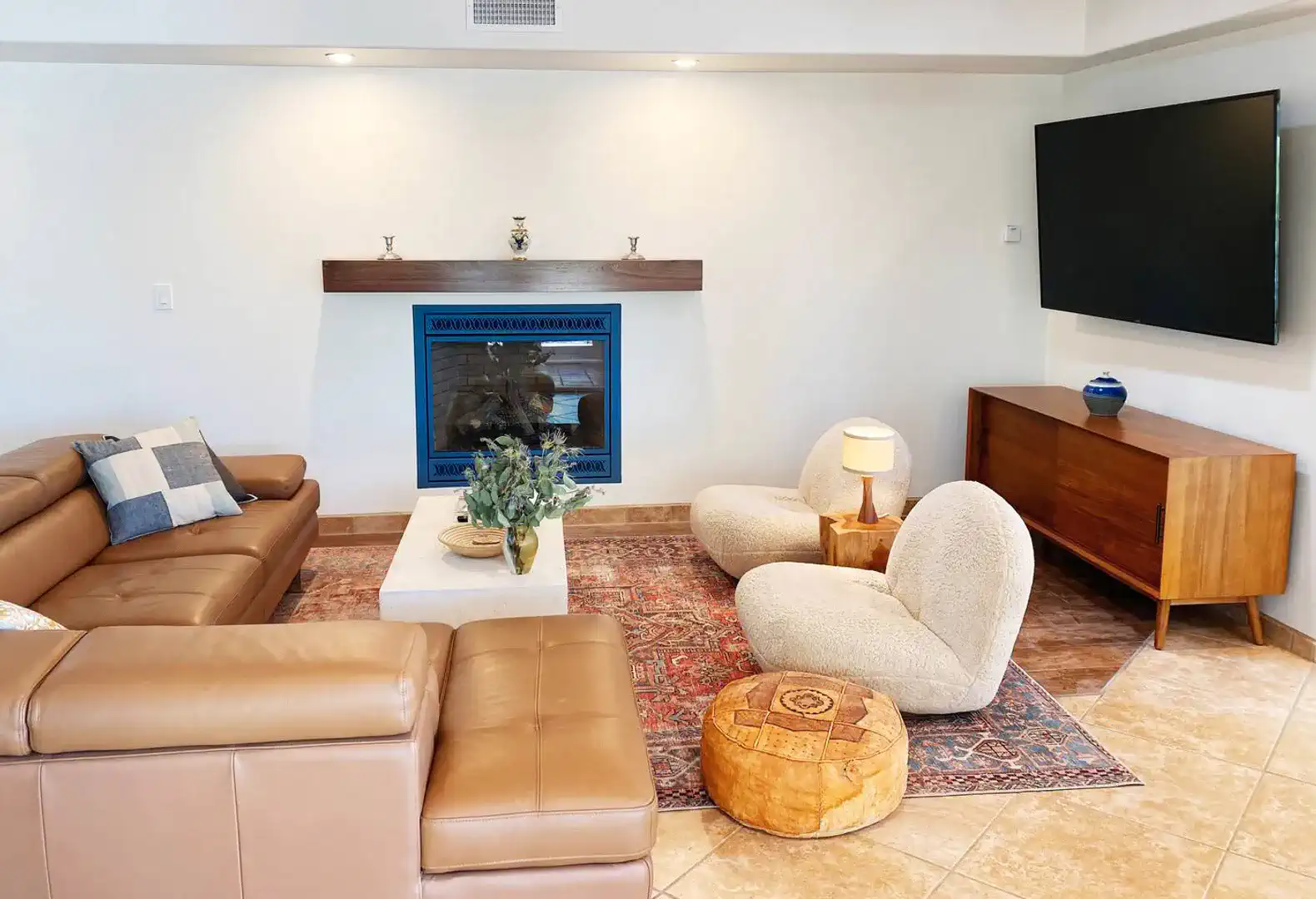 Cozy living room with a fireplace, modern furniture, and decorative accents