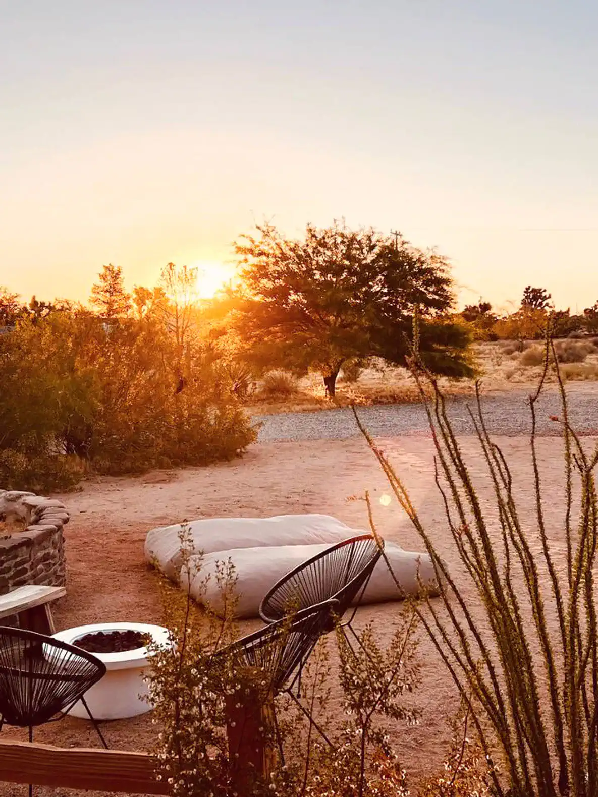 Sunset view with fire pit and outdoor seating in a desert landscape